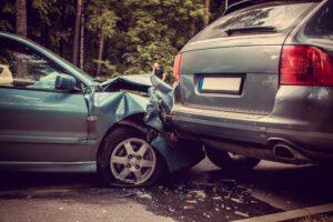 Car accident involving two vehicles with front-end damage on the road.