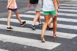 Pedestrians walking across a crosswalk in Florida.