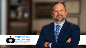 Professional lawyer in blue suit with arms crossed in office setting.