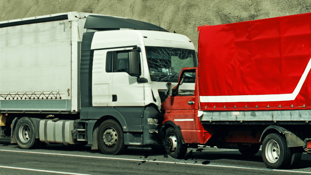 Commercial truck accident involving a white semi-truck and a red delivery truck after a highway collision, , a common truck accidents handled by The Dash Cam Lawyer
