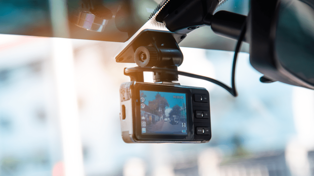 Dash cam mounted on a car windshield recording road footage as evidence for a personal injury car accident claim in West Palm Beach Florida